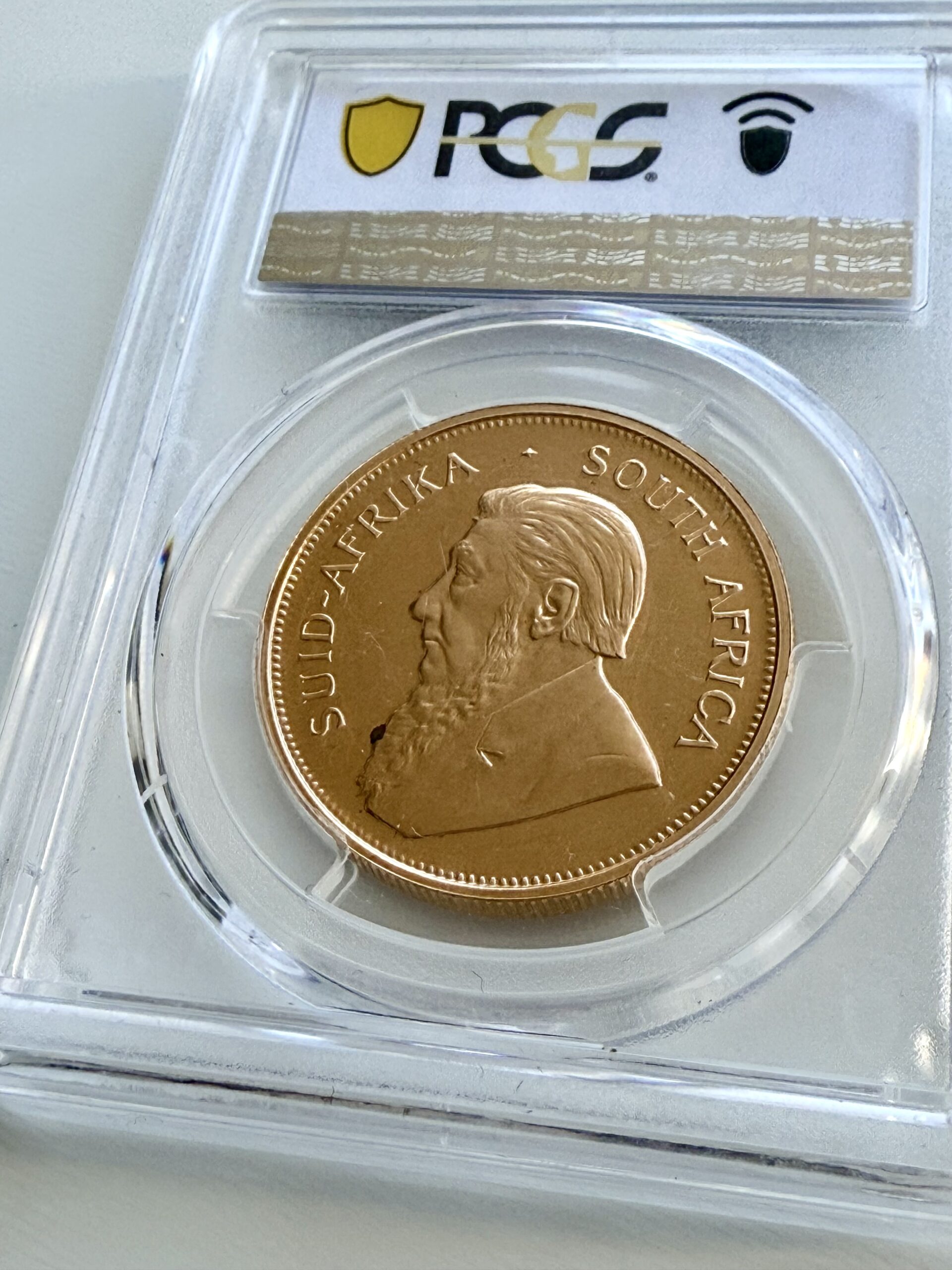 kruegerrand–1973–1oz-gold-pcgs-pr67-cam_6 Krugerrand 1973 1 oz Goldmünze in Proof-Qualität, PCGS PR67 CAM – historische südafrikanische Sammlermünze mit Paul-Kruger-Motiv