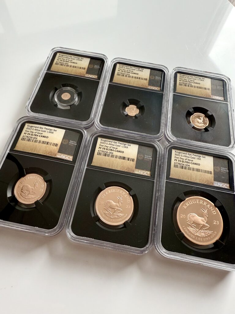Krugerrand 2023 1 oz Gold Proof in NGC holder (Black Core) with label “PF70 ULTRA CAMEO – First Day of Issue”; reverse with springbok and inscription “FYNGOUD 1 OZ FINE GOLD”.