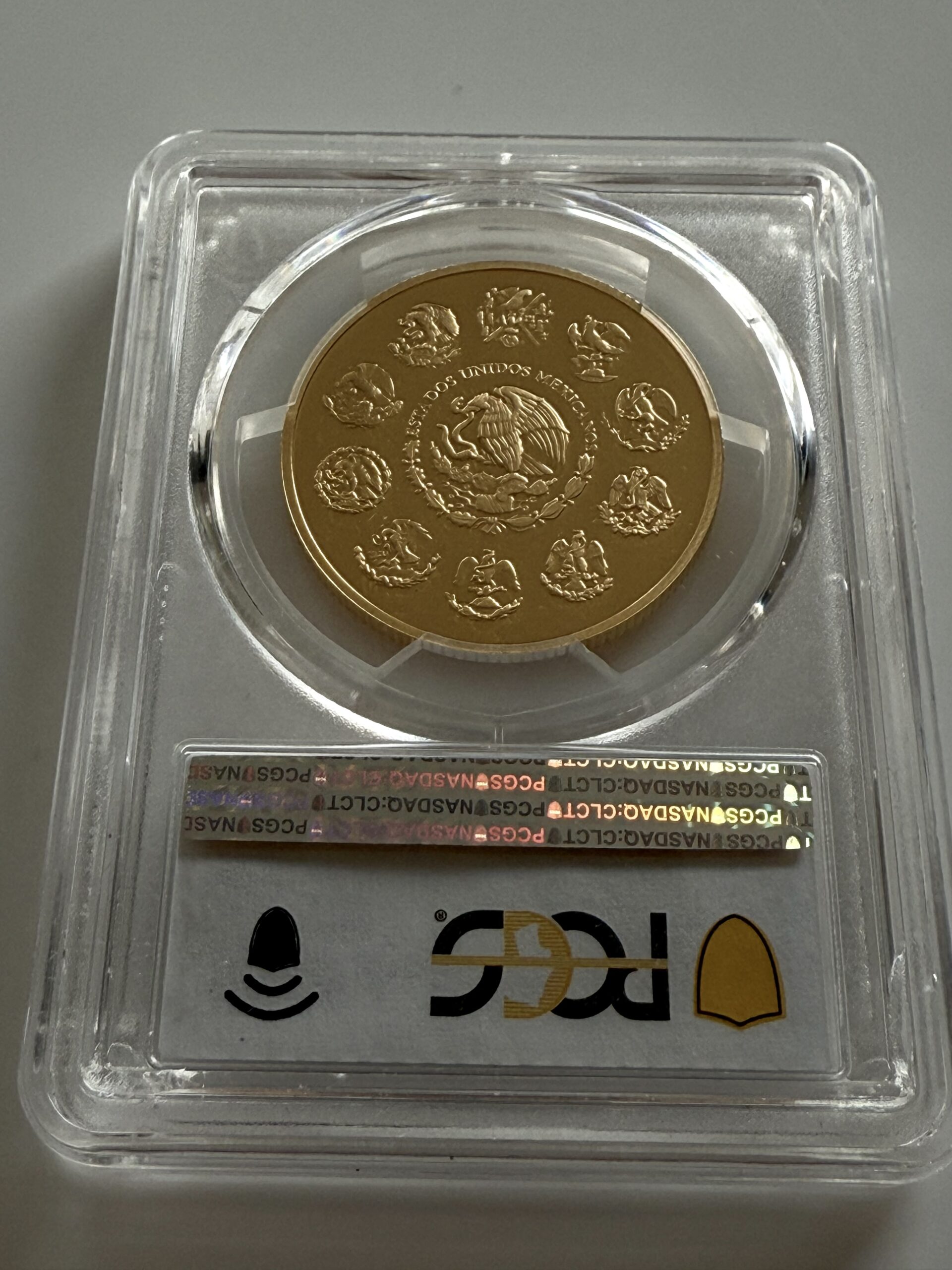 mexiko-2019-libertad-1-oz-proof-goldmunze-pcgs-pr70-dcam_3 Mexiko 2019 Libertad 1 Onza Gold Proof im PCGS-Slab PR70DCAM; Vorderseite mit Victoria (Ángel de la Independencia) vor Popocatépetl und Iztaccíhuatl.