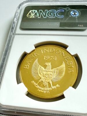 印度尼西亚-1974-100000-印尼盾-科莫多-龙-金-NGC-PF68-ucam_2 Indonesien 1974 100000 Rupiah Goldmünze Komodowaran im NGC-Holder PF68 Ultra Cameo, Revers mit Waranmotiv und Nennwert Rp100000, schräg fotografiert.