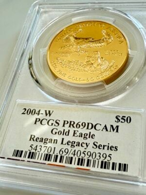usa-american-eagle-gold-proof-2004-50-us-dollar_3 USA 2004 American Eagle 1oz Gold Proof 50 Dollars, Liberty with torch and olive branch, year 2004 with W-Mintmark, in PCGS holder with Reagan Legacy Series Michael Reagan signature label, photographed at an angle.