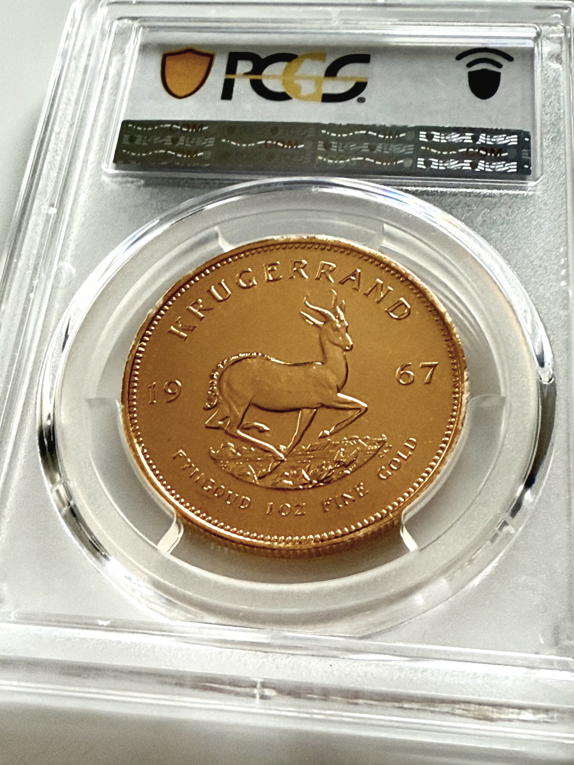 kruegerrand-1967-1oz-pcgs-pl66_2 PCGS zertifizierter Krügerrand 1967 zu 1 oz Gold, Einstufung PL66, Vorderseite im Original PCGS Holder.