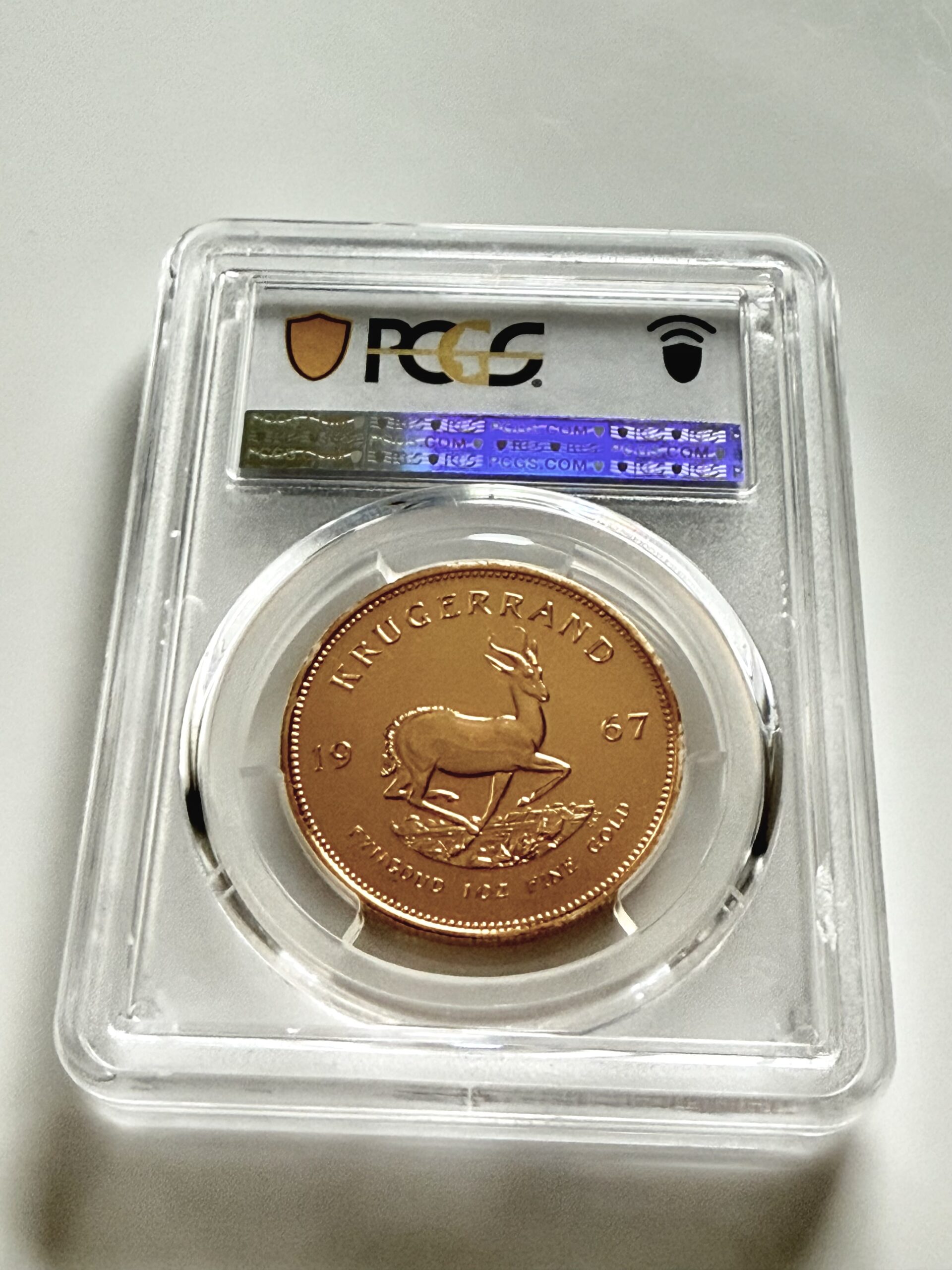 kruegerrand-1967-1oz-pcgs-pl66_3 PCGS zertifizierter Krügerrand 1967 zu 1 oz Gold, Einstufung PL66, Vorderseite im Original PCGS Holder.
