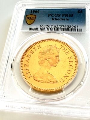 Rhodesia 1966 5 Pounds Gold Proof in PCGS slab with grade PR65 and portrait of Queen Elizabeth II.